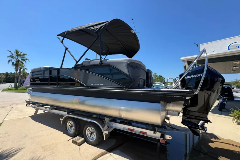 Slide: The Image of 2026 Bennington 22 MFB pontoon boat on trailer, featuring a Mercury outboard motor. - 14