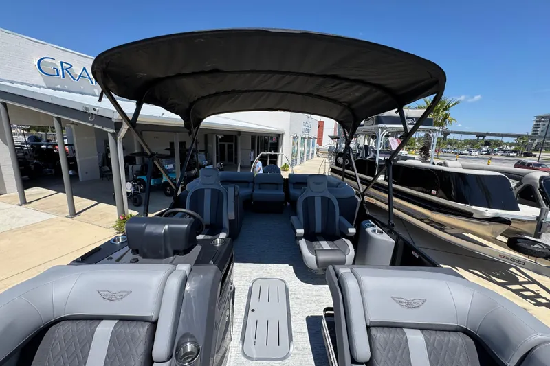 Slide: The Image of 2026 Bennington 22 MFB boat interior with seating and canopy, displayed outdoors. - 20