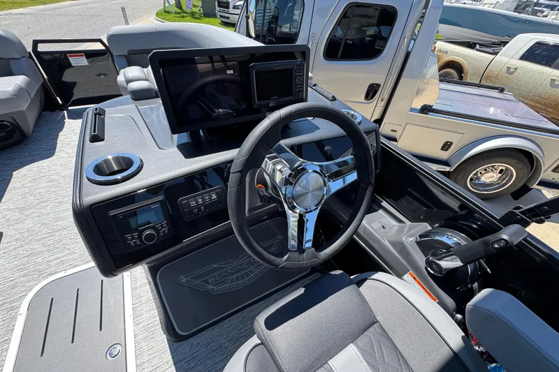 Slide: The Image of 2026 Bennington 22 MFB boat dashboard with steering wheel and modern controls. - 23