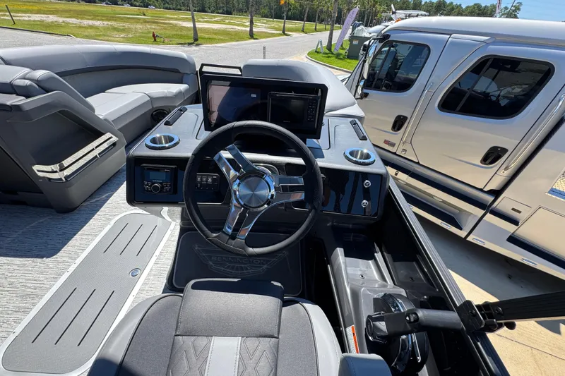 Slide: The Image of Interior view of 2026 Bennington 22 MFB boat with modern steering and dashboard. - 24
