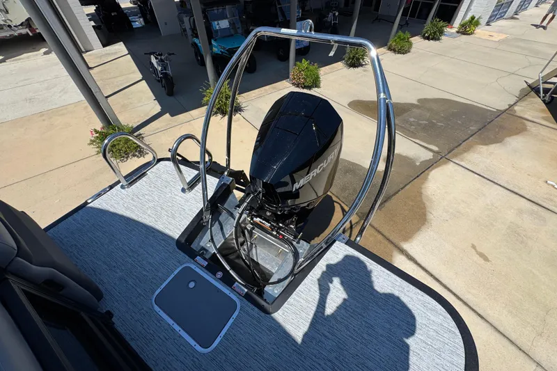 Slide: The Image of 2026 Bennington 22 MFB boat with Mercury outboard motor, docked on concrete surface. - 31