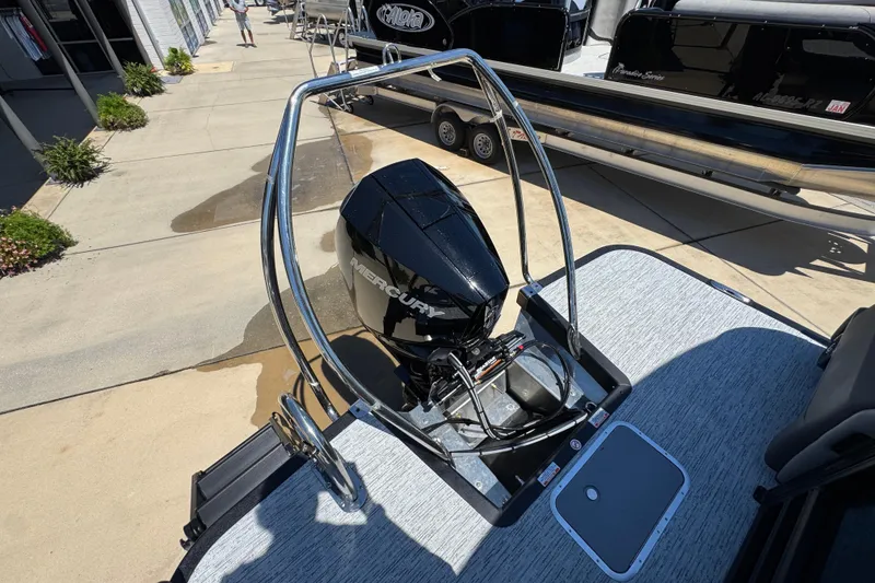 Slide: The Image of 2026 Bennington 22 MFB boat with Mercury engine, displayed outdoors. - 32