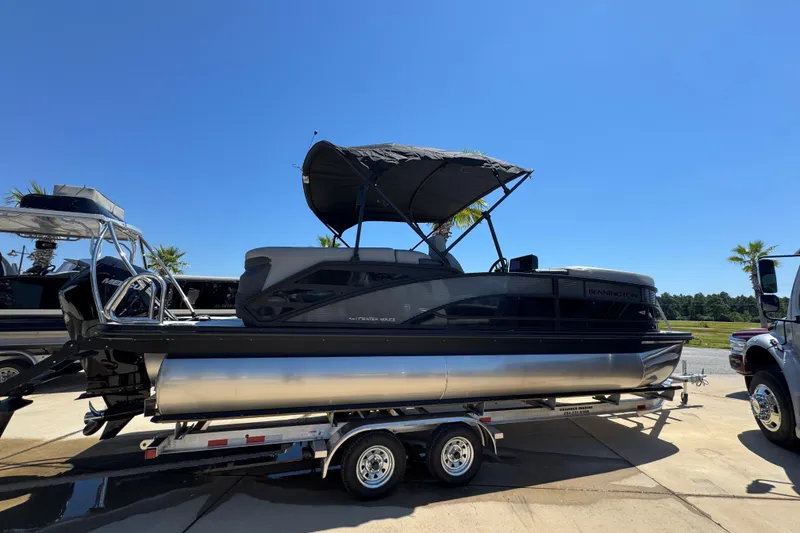 Slide: The Image of 2026 Bennington 22 MFB pontoon boat on trailer under clear blue sky. - 7