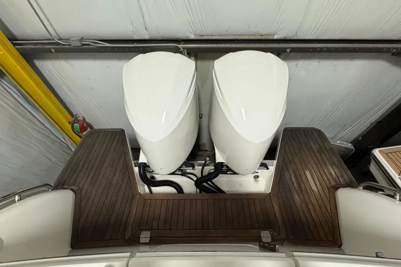 Slide: The Image of 2020 Back Cove 34O boat with dual outboard engines and wooden deck. - 16