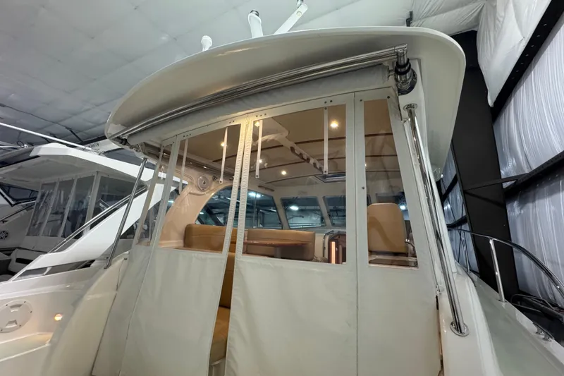 Slide: The Image of 2020 Back Cove 34O yacht interior with enclosed seating area in a showroom. - 18