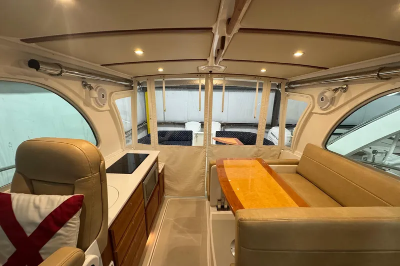 Slide: The Image of 2020 Back Cove 34O interior with modern seating, table, and kitchenette. - 24
