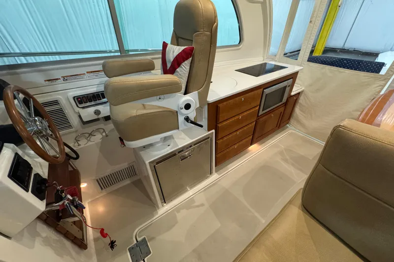 Slide: The Image of Interior of 2020 Back Cove 34O boat with helm, seating, and kitchenette. - 25