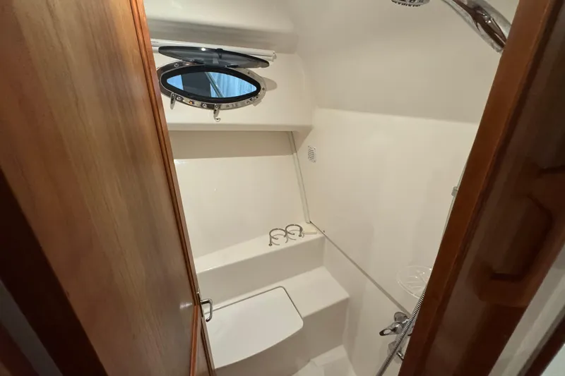 Slide: The Image of 2020 Back Cove 34O yacht bathroom with porthole and shower. - 29