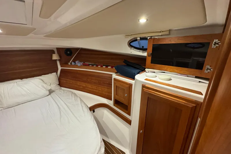 Slide: The Image of Cozy cabin interior of 2020 Back Cove 34O with wood accents and porthole. - 30