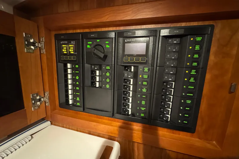 Slide: The Image of Electrical panel inside 2020 Back Cove 34O boat, featuring switches and indicators. - 33