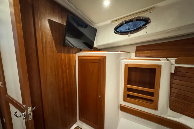 Slide: The Image of Interior of 2020 Back Cove 34O yacht with wooden cabinetry and mounted TV. - 35