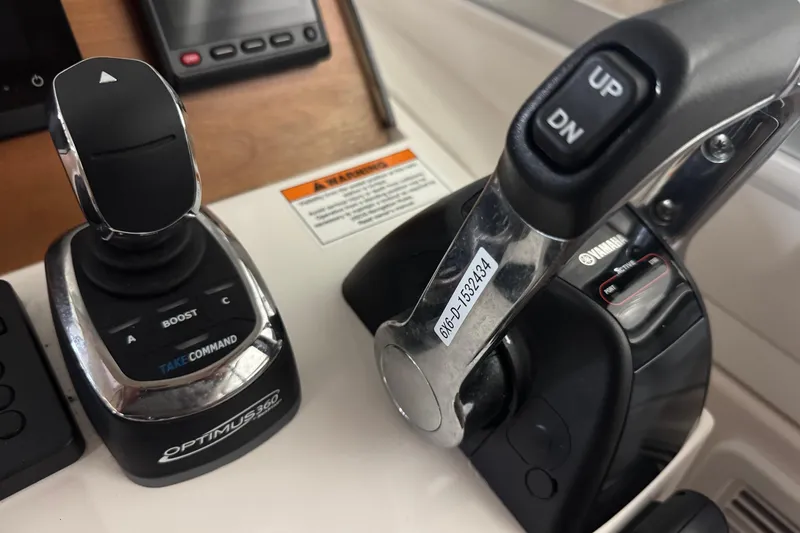 Slide: The Image of Control panel of a 2020 Back Cove 34O boat with joystick and throttle. - 36