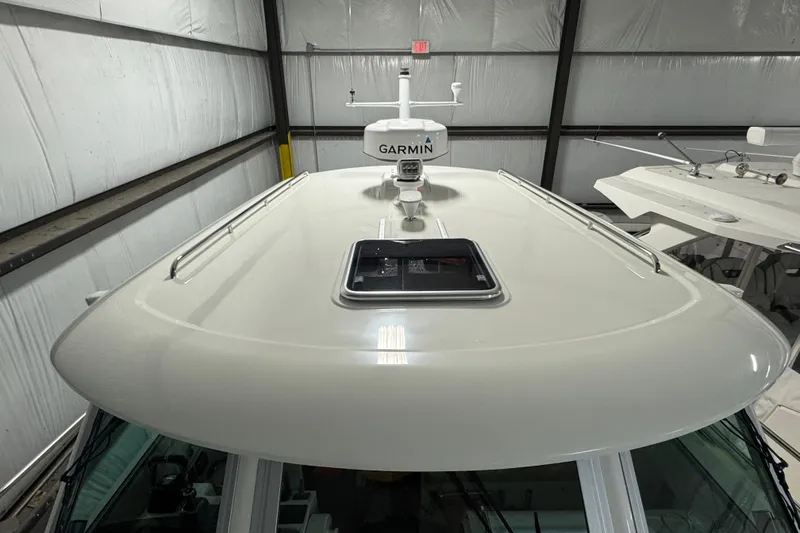 Slide: The Image of 2020 Back Cove 34O boat roof with Garmin radar in a storage facility. - 37