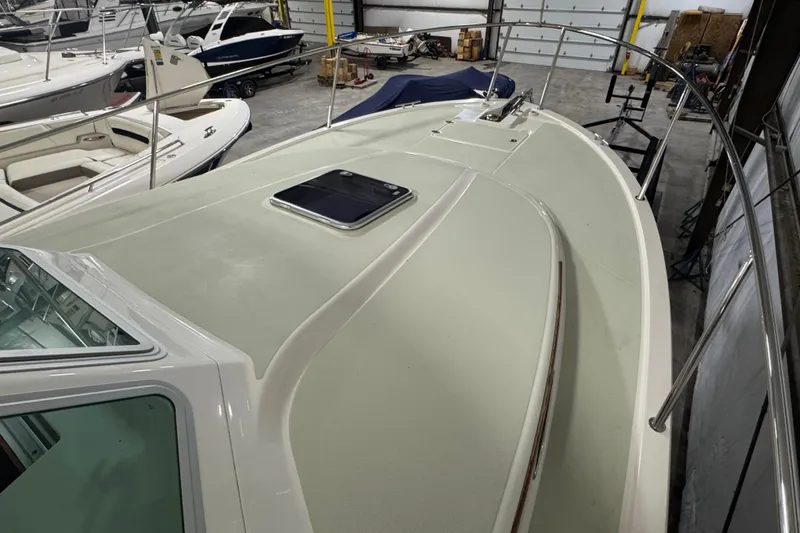Slide: The Image of 2020 Back Cove 34O boat in storage, showcasing sleek deck design and railing. - 38