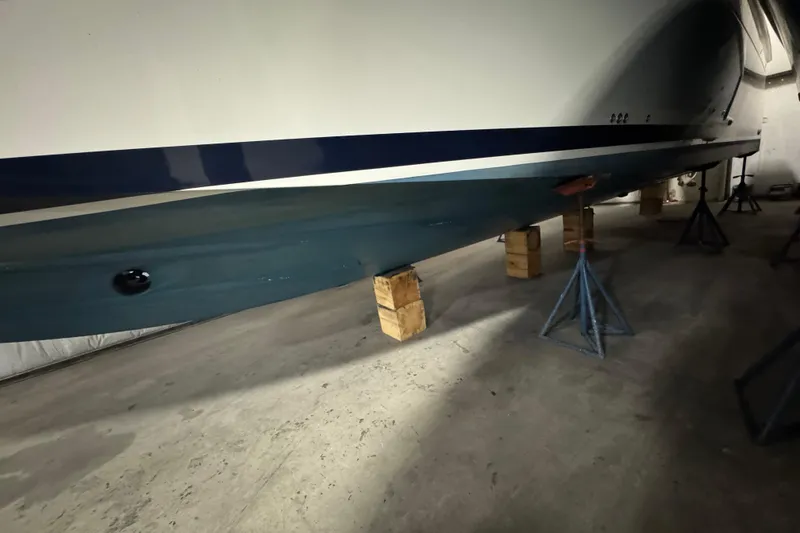 Slide: The Image of 2020 Back Cove 34O boat hull on stands in a storage facility. - 39