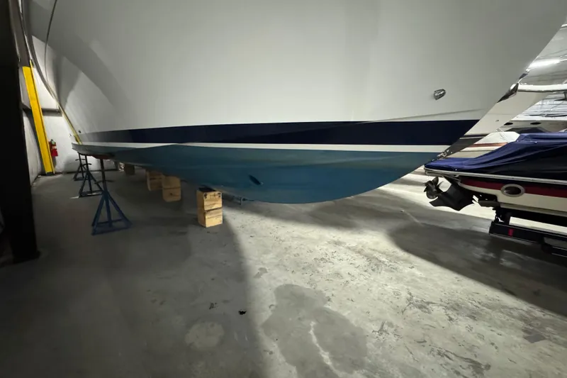Slide: The Image of 2020 Back Cove 34O boat hull in storage, supported by stands and blocks. - 40