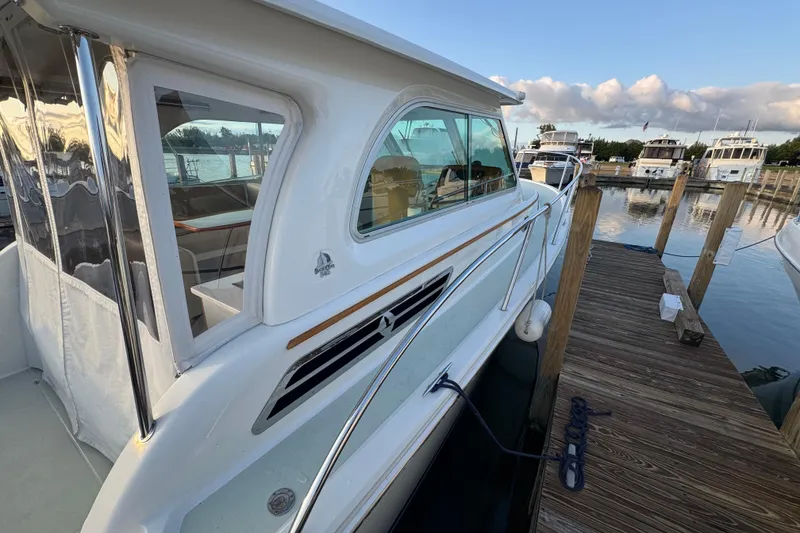 Slide: The Image of 2020 Back Cove 34O yacht docked at marina, showcasing sleek design and modern features. - 7