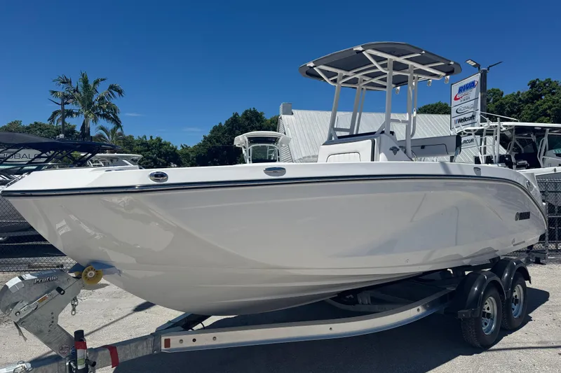 Slide: The Image of 2026 Yamaha Boats 220 FSH Sport on trailer, displayed outdoors under clear blue sky. - 1