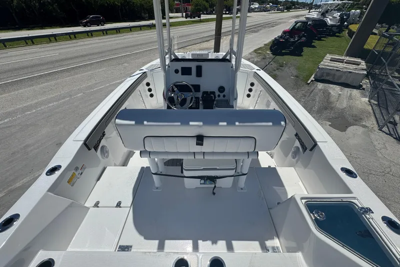 Slide: The Image of 2026 Yamaha Boats 220 FSH Sport, sleek white deck, parked roadside. - 3