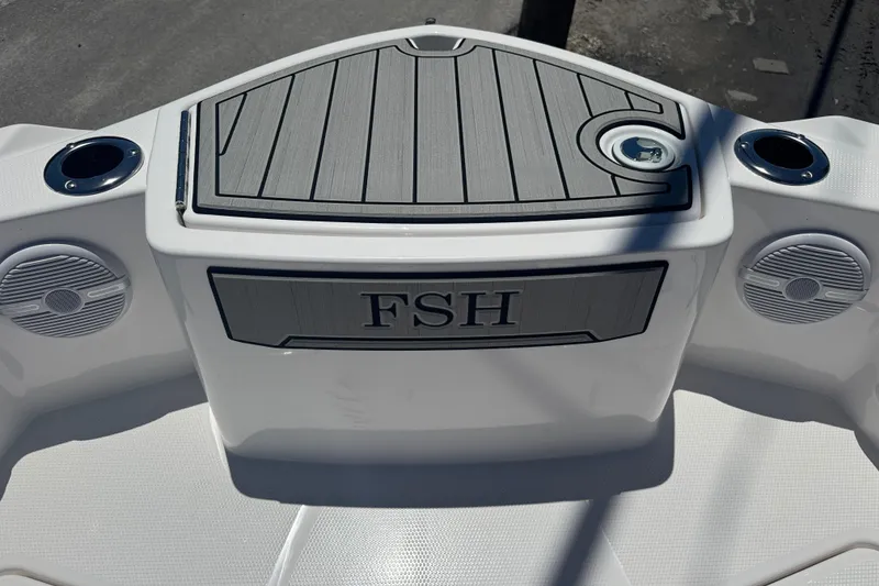 Slide: The Image of 2026 Yamaha Boats 220 FSH Sport deck with speakers and cup holders. - 8