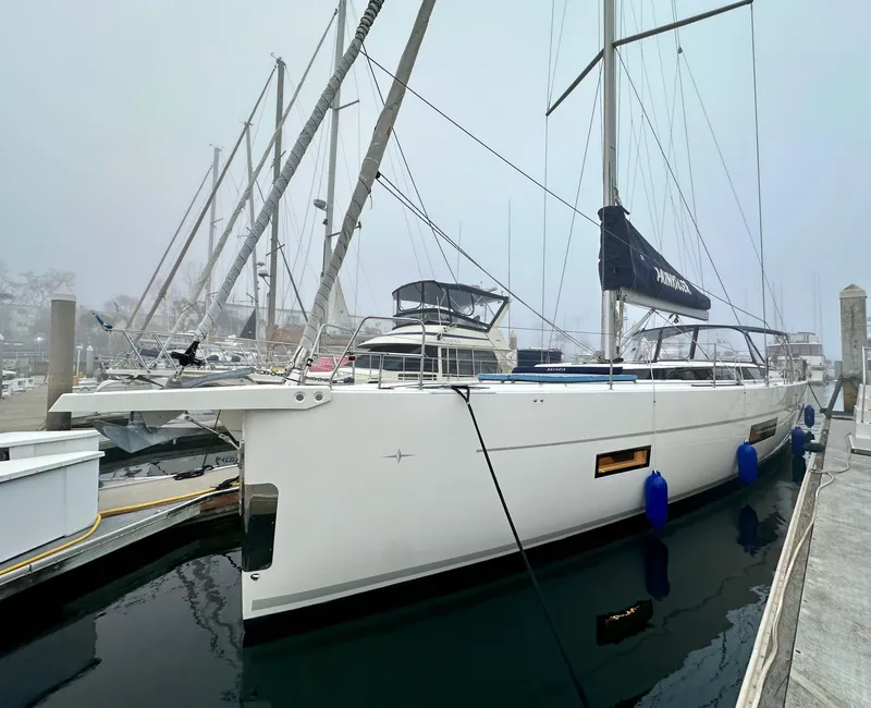 Slide: The Image of 2020 Bavaria C50 yacht docked at marina on a foggy day. - 1