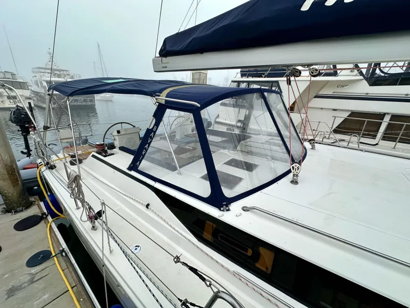 Slide: The Image of 2020 Bavaria C50 yacht docked at marina, featuring blue canopy and sleek design. - 12
