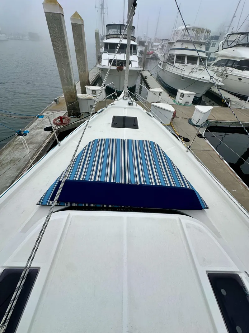 Slide: The Image of Bavaria C50 yacht docked at marina, 2020 model, with striped deck cover. - 14