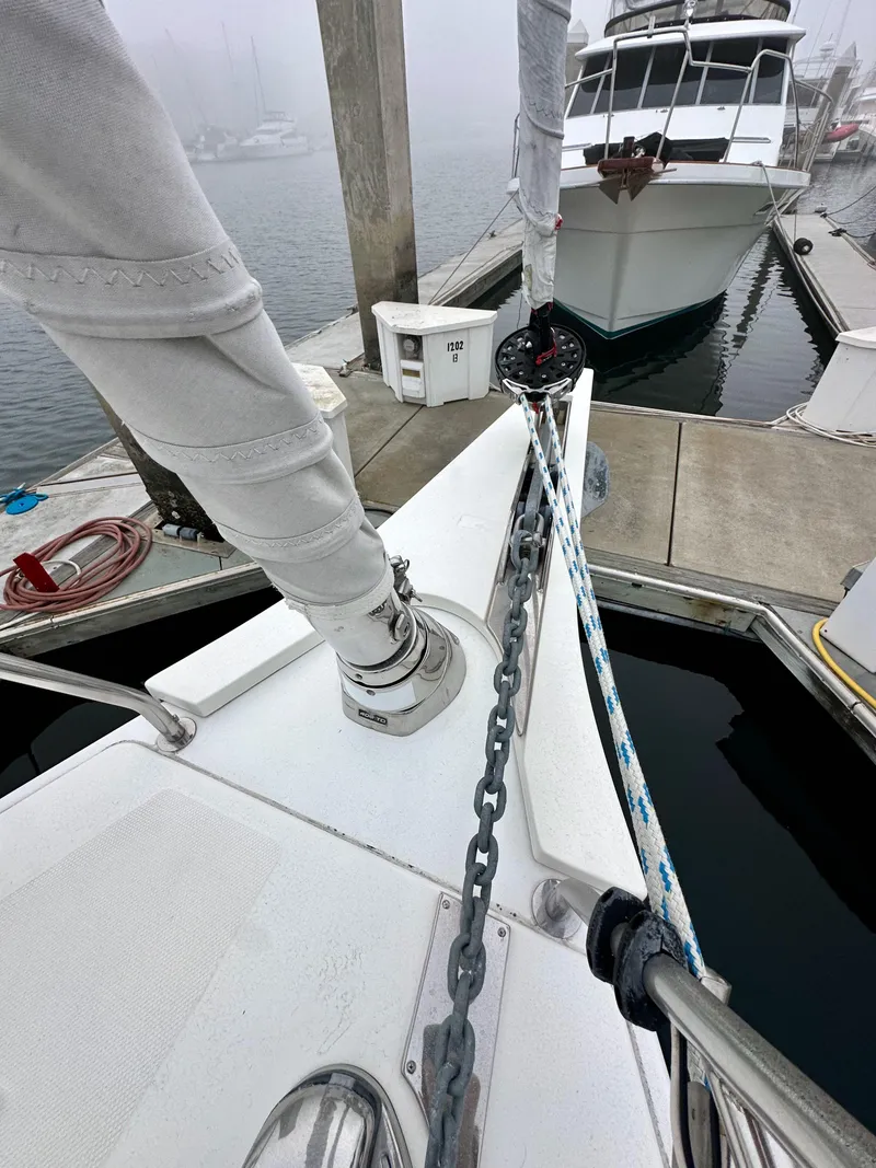 Slide: The Image of Bavaria C50 yacht docked at marina, showcasing anchor chain and deck details. - 18