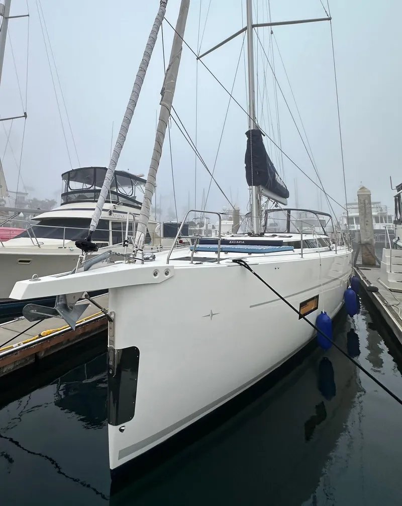 Slide: The Image of 2020 Bavaria C50 yacht docked in a marina on a foggy day. - 2