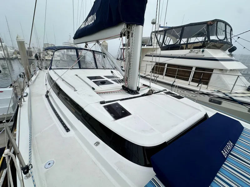 Slide: The Image of 2020 Bavaria C50 yacht docked at marina, showcasing sleek design and spacious deck. - 21