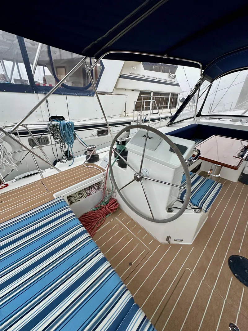 Slide: The Image of 2020 Bavaria C50 yacht cockpit with striped seating and steering wheel. - 26