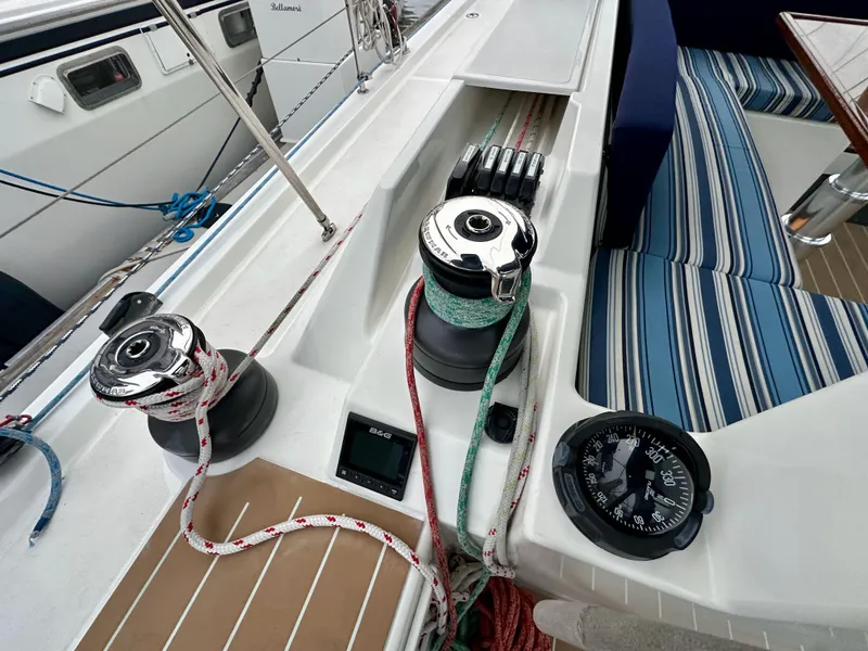Slide: The Image of Bavaria C50 yacht deck with winches, ropes, and compass, 2020 model. - 28