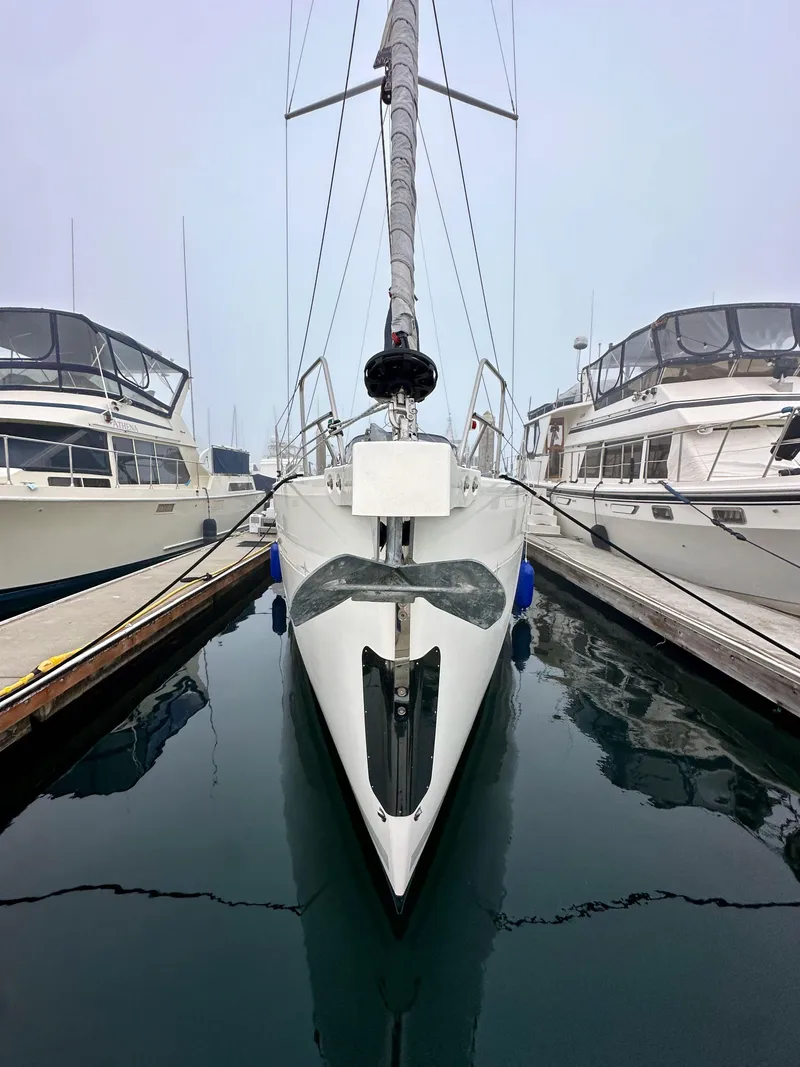 Slide: The Image of Front view of a 2020 Bavaria C50 yacht docked between two boats. - 3