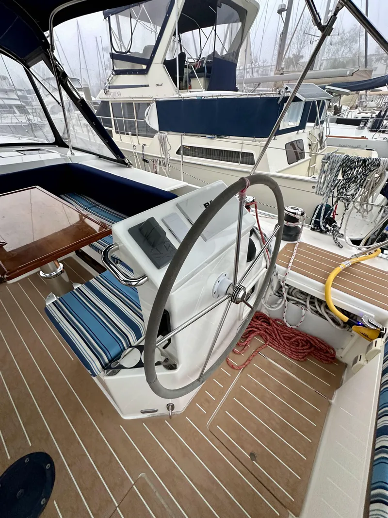 Slide: The Image of 2020 Bavaria C50 yacht cockpit with steering wheel and striped seating. - 31