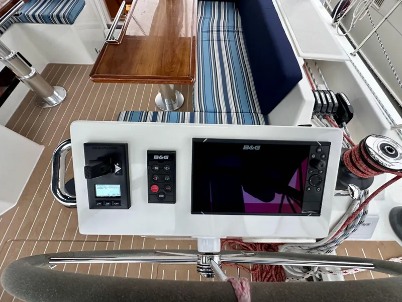 Slide: The Image of Cockpit of 2020 Bavaria C50 yacht with navigation equipment and striped seating. - 32
