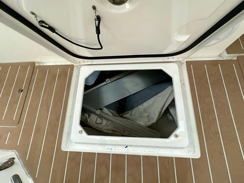 Slide: The Image of Open hatch on 2020 Bavaria C50 yacht deck, revealing storage compartment. - 35