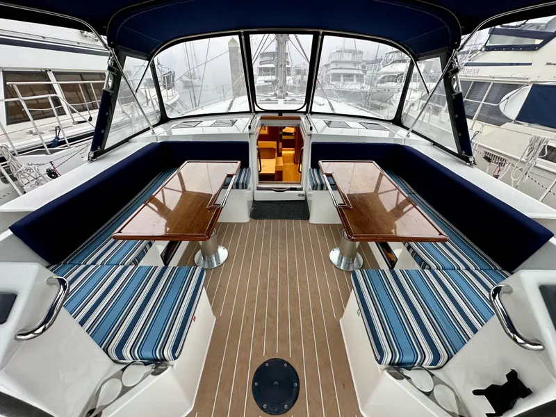 Slide: The Image of Interior of 2020 Bavaria C50 yacht with striped seating and wooden tables. - 36