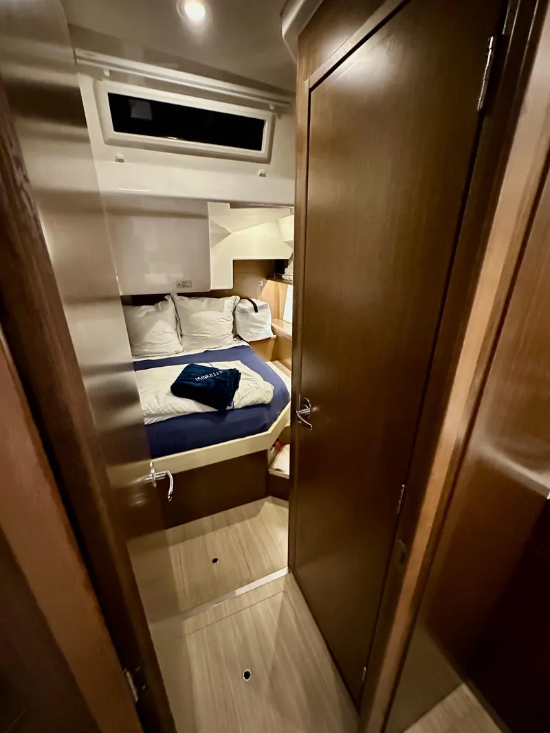 Slide: The Image of Interior cabin of 2020 Bavaria C50 yacht, featuring cozy bed and wooden furnishings. - 45