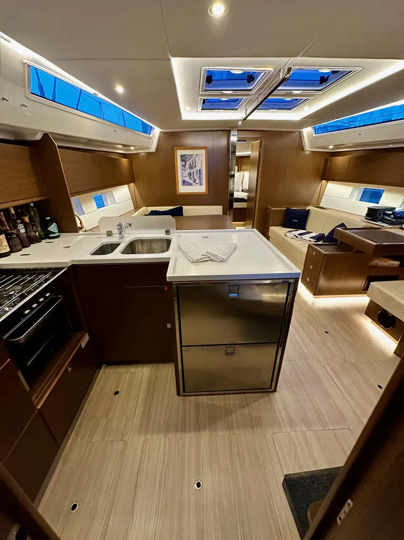 Slide: The Image of Interior of 2020 Bavaria C50 yacht, featuring modern kitchen and seating area. - 49
