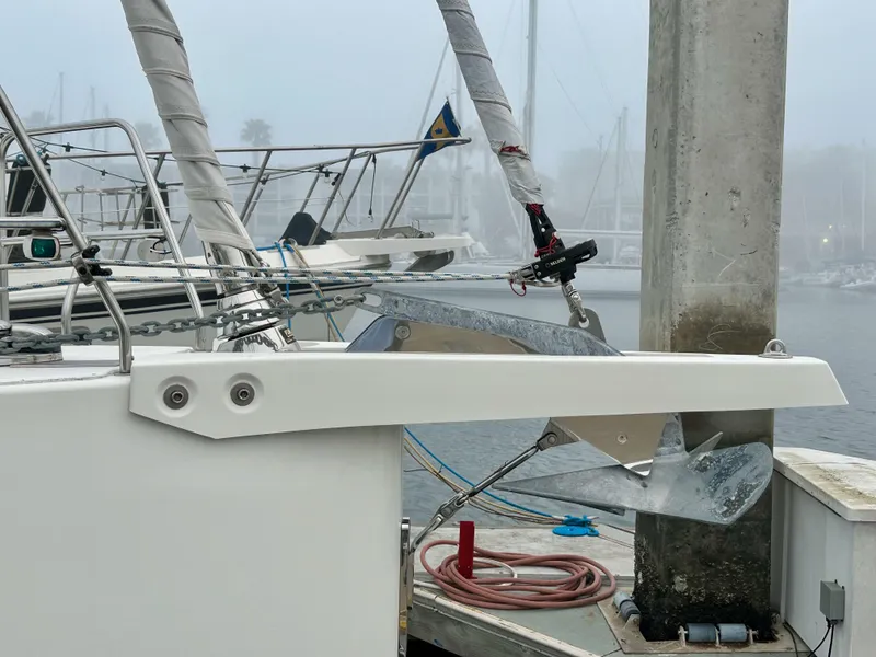 Slide: The Image of Bavaria C50 yacht docked in a foggy marina, showcasing anchor and rigging. - 6