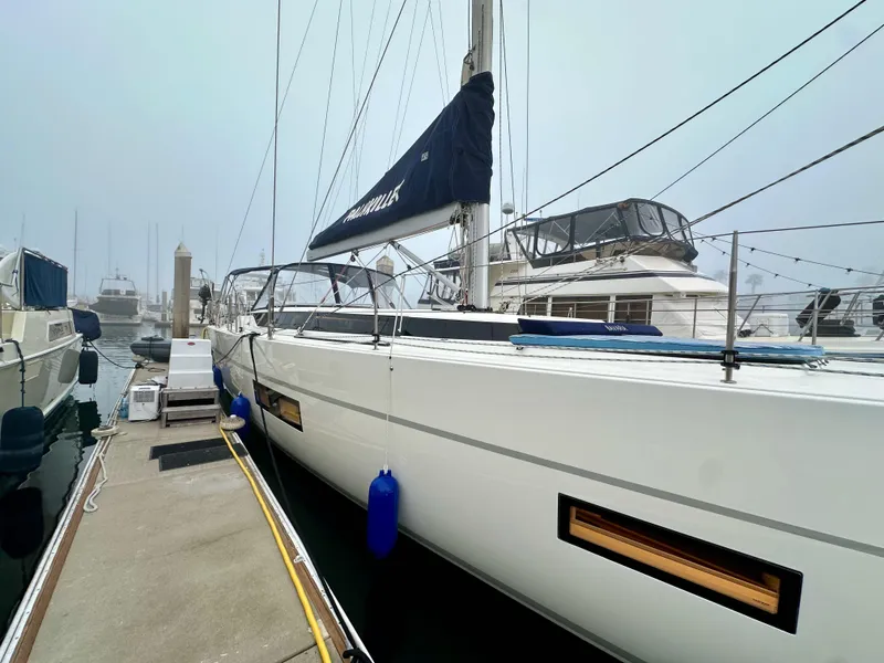 Slide: The Image of 2020 Bavaria C50 yacht docked at marina, featuring sleek design and modern amenities. - 7