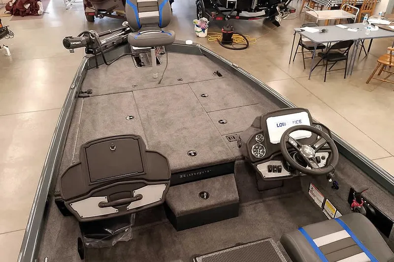Slide: The Image of 2026 Ranger RT198P fishing boat interior with steering console and seating in showroom. - 12