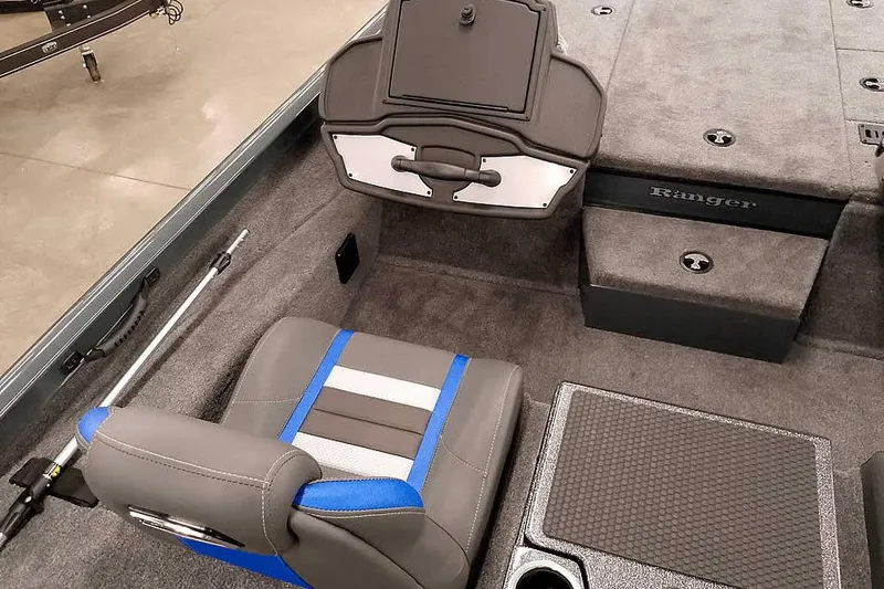 Slide: The Image of 2026 Ranger RT198P boat interior with gray and blue seating, carpeted flooring, and storage compartments. - 21
