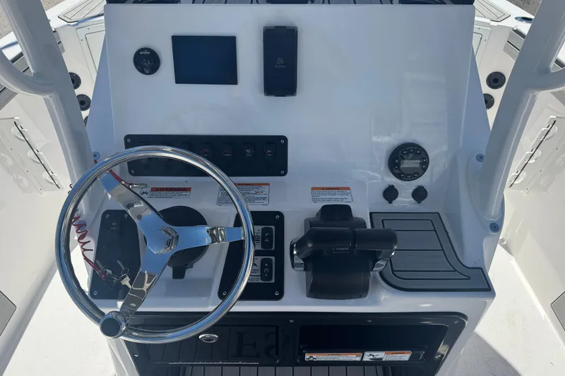 Slide: The Image of 2026 Yamaha Boats 220 FSH Sport dashboard with steering wheel and controls. - 6