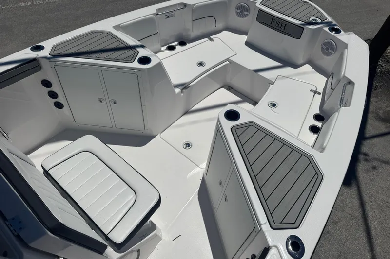 Slide: The Image of 2026 Yamaha Boats 220 FSH Sport interior with seating and storage compartments. - 7