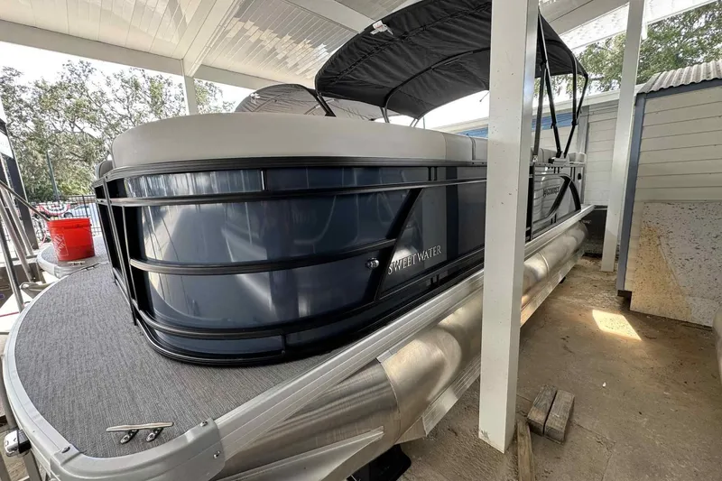 The Image of 2025 Sweetwater 2086 CSE pontoon boat under a canopy, showcasing sleek design and modern features. - 0