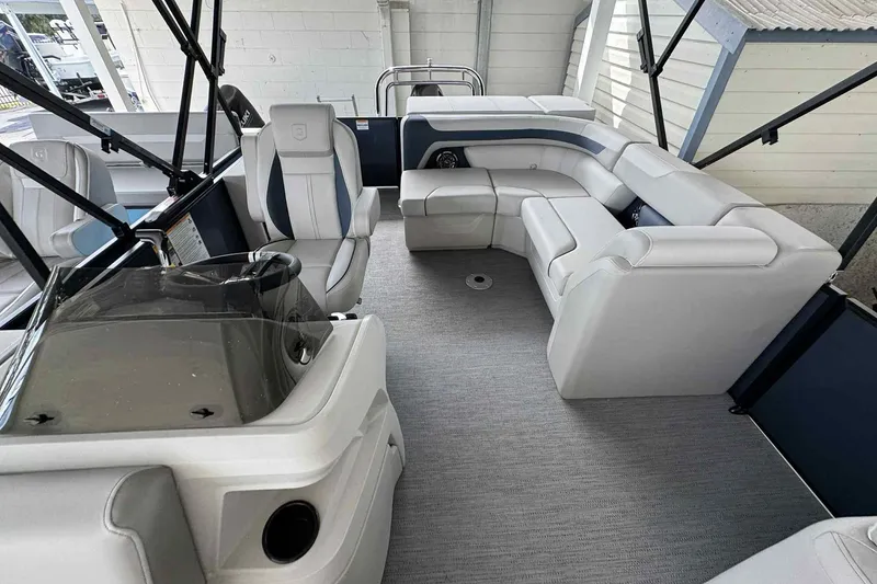 Slide: The Image of Interior of 2025 Sweetwater 2086 CSE boat with modern seating and helm. - 2