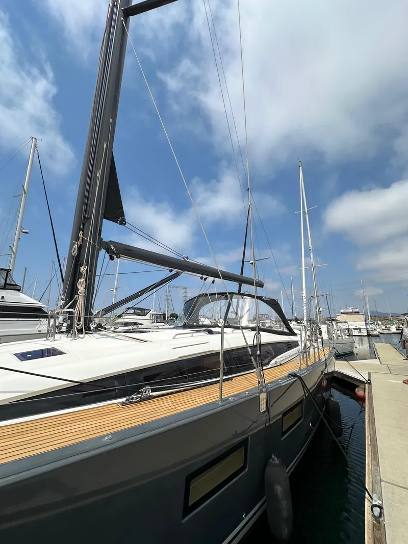 Slide: The Image of 2018 Jeanneau 54 yacht docked at marina under blue sky. - 17