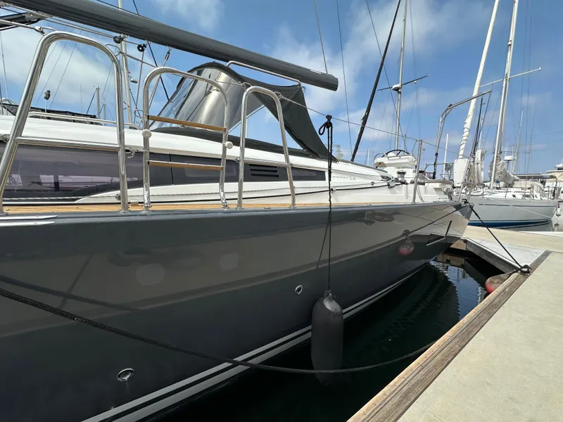 Slide: The Image of 2018 Jeanneau 54 yacht docked at marina, sleek design, clear blue sky. - 19