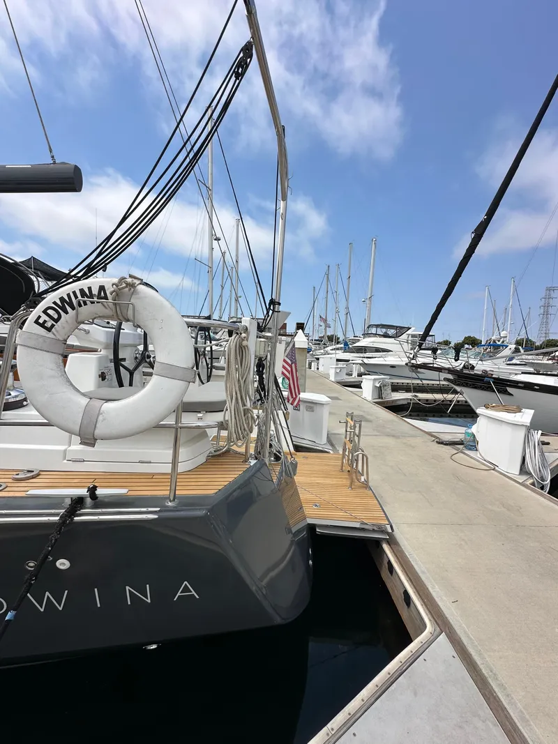 Slide: The Image of Jeanneau 54 yacht docked at marina, 2018 model, with clear blue sky. - 21